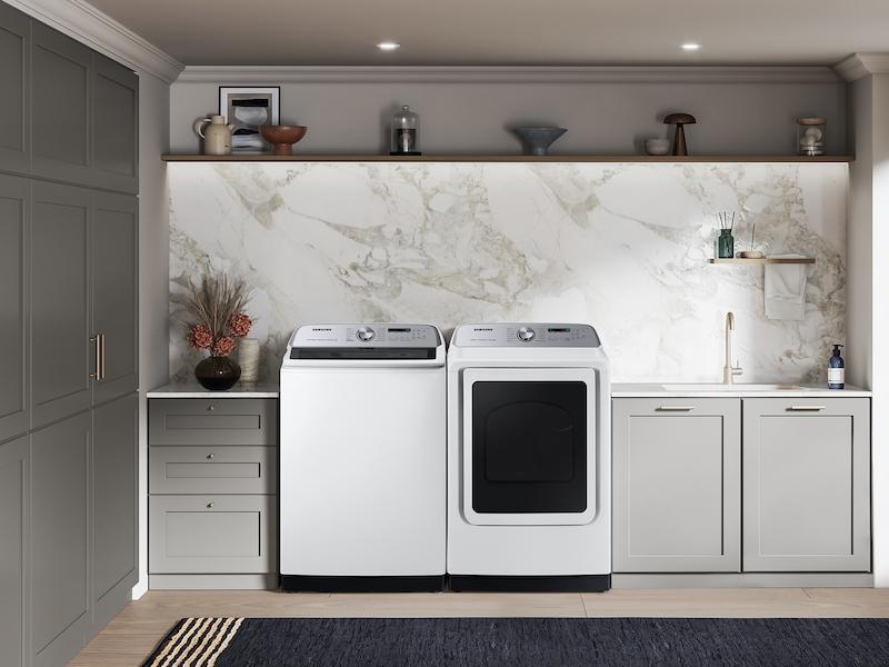 Washer shown paired with a matching dryer in a marble-backsplash laundry room, lifestyle shot