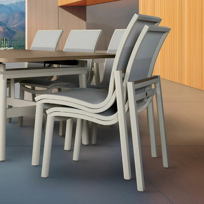Detail view of stacked sling chairs beside the extended dining table