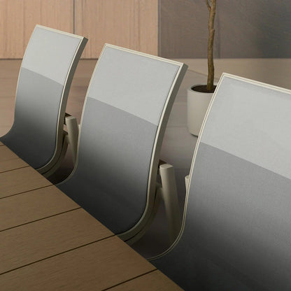 Close-up of the sling chair backs showing the ombre gray fade fabric pattern