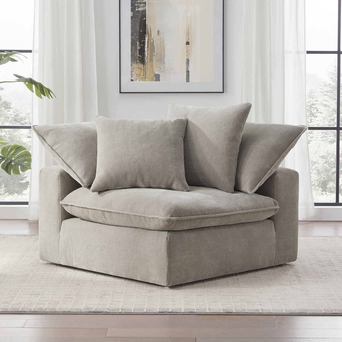 Aiden & Ivy Sereen Fabric Corner Chair in Taupe with 2 pillows, angled lifestyle view