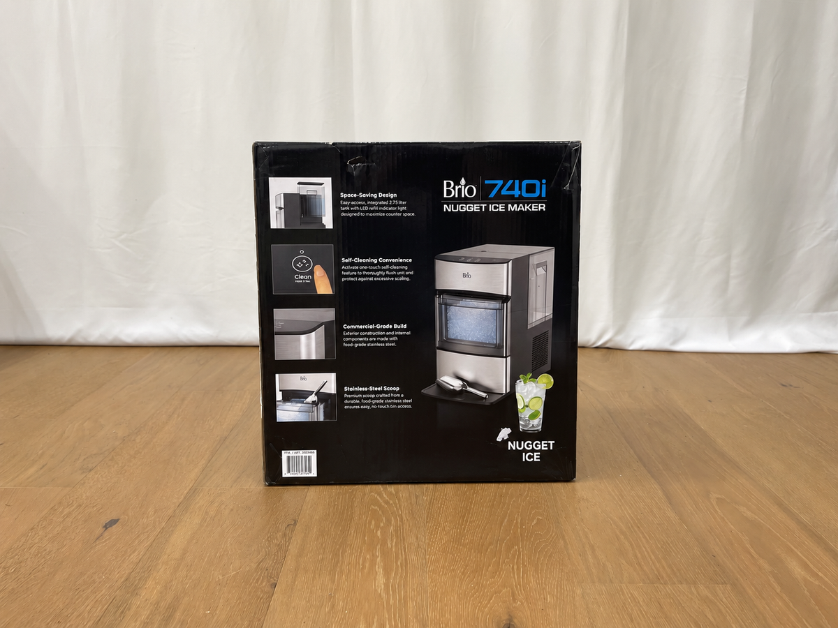 Brio 740i Nugget Ice Maker retail packaging box standing upright on a wooden floor against a draped white fabric backdrop.