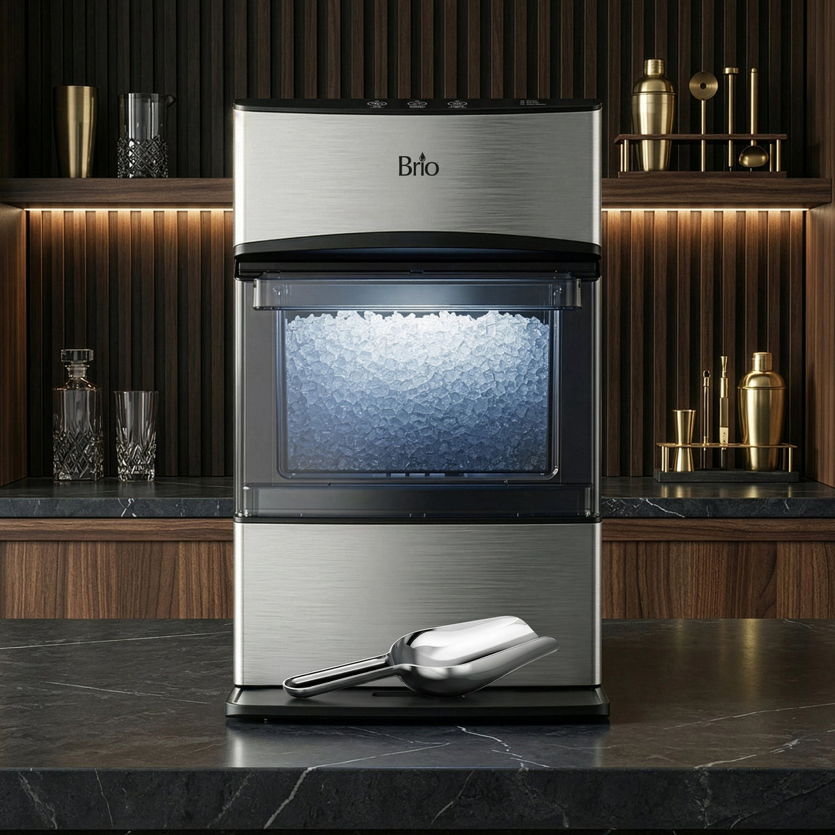 Brio 740i ice maker styled on a home bar counter surrounded by cocktail glassware and barware
