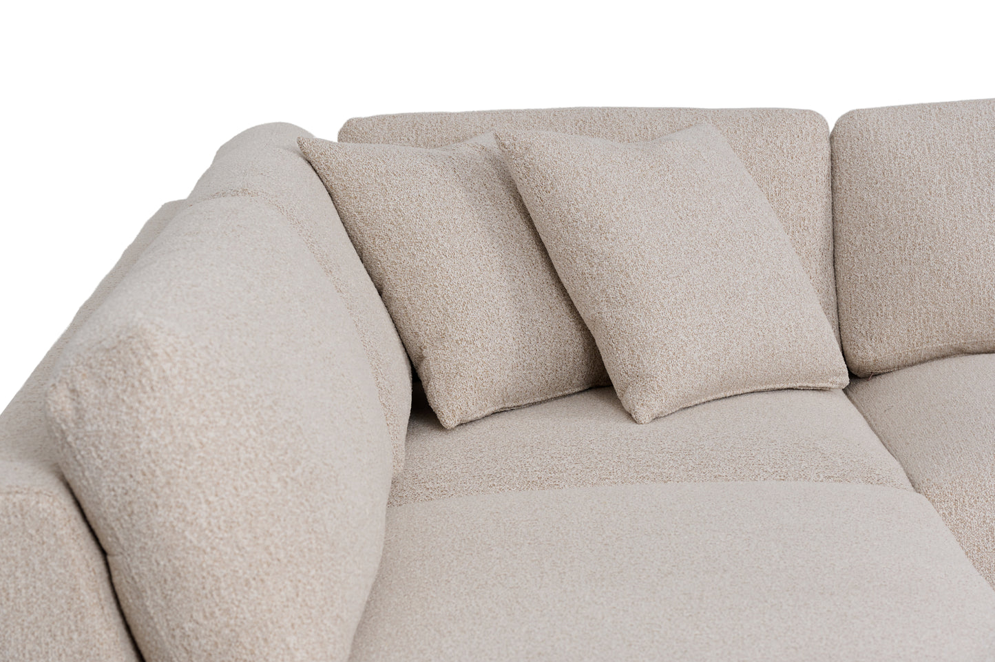 Close-up of the sectional back cushions and two coordinating boucle throw pillows