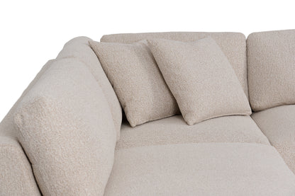 Close-up of the sectional back cushions and two coordinating boucle throw pillows