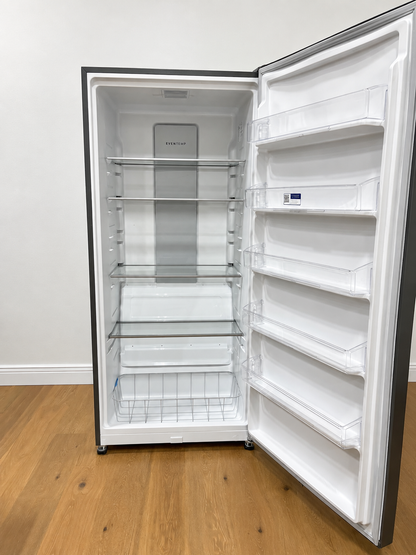 An empty side-by-side refrigerator with its door open, showing the white interior shelves, glass shelves, and door bins. 