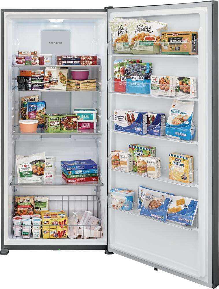 Freezer with door open, fully stocked with frozen food packages on shelves and in door bins