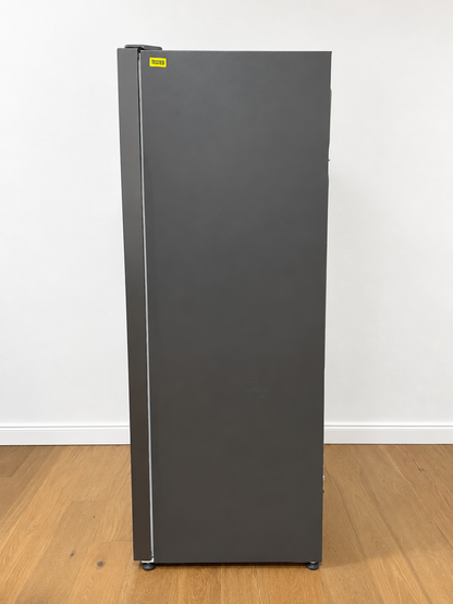 A tall, dark gray single-door refrigerator or freezer stands upright.
