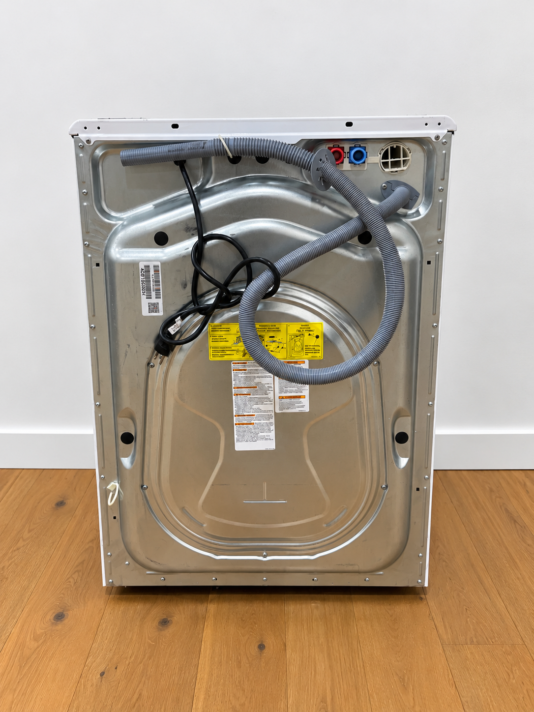 Washer rear panel view showing water supply and drain hose connections