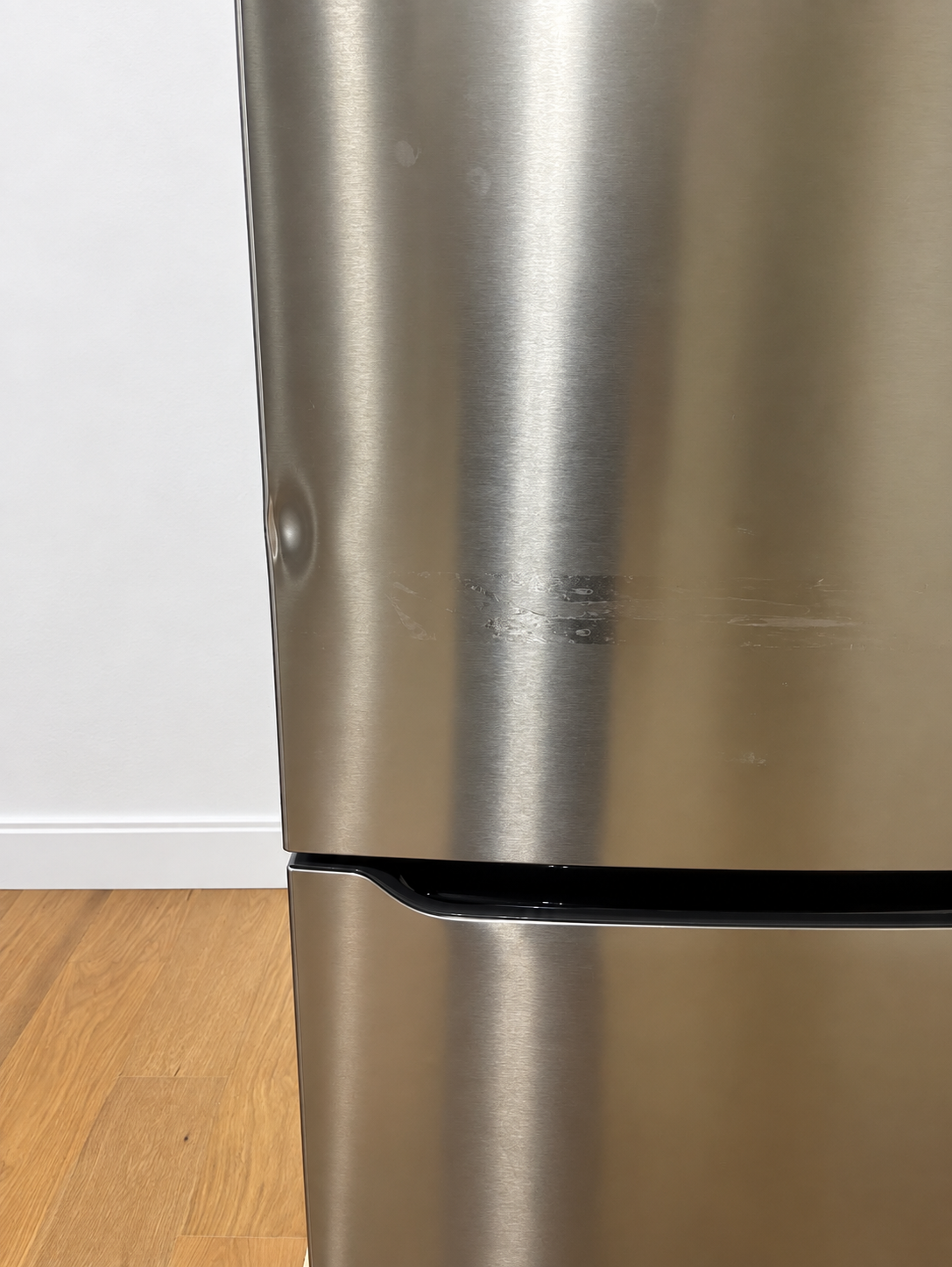 Close-up of the actual unit's side panel showing light scuff marks near the handle area