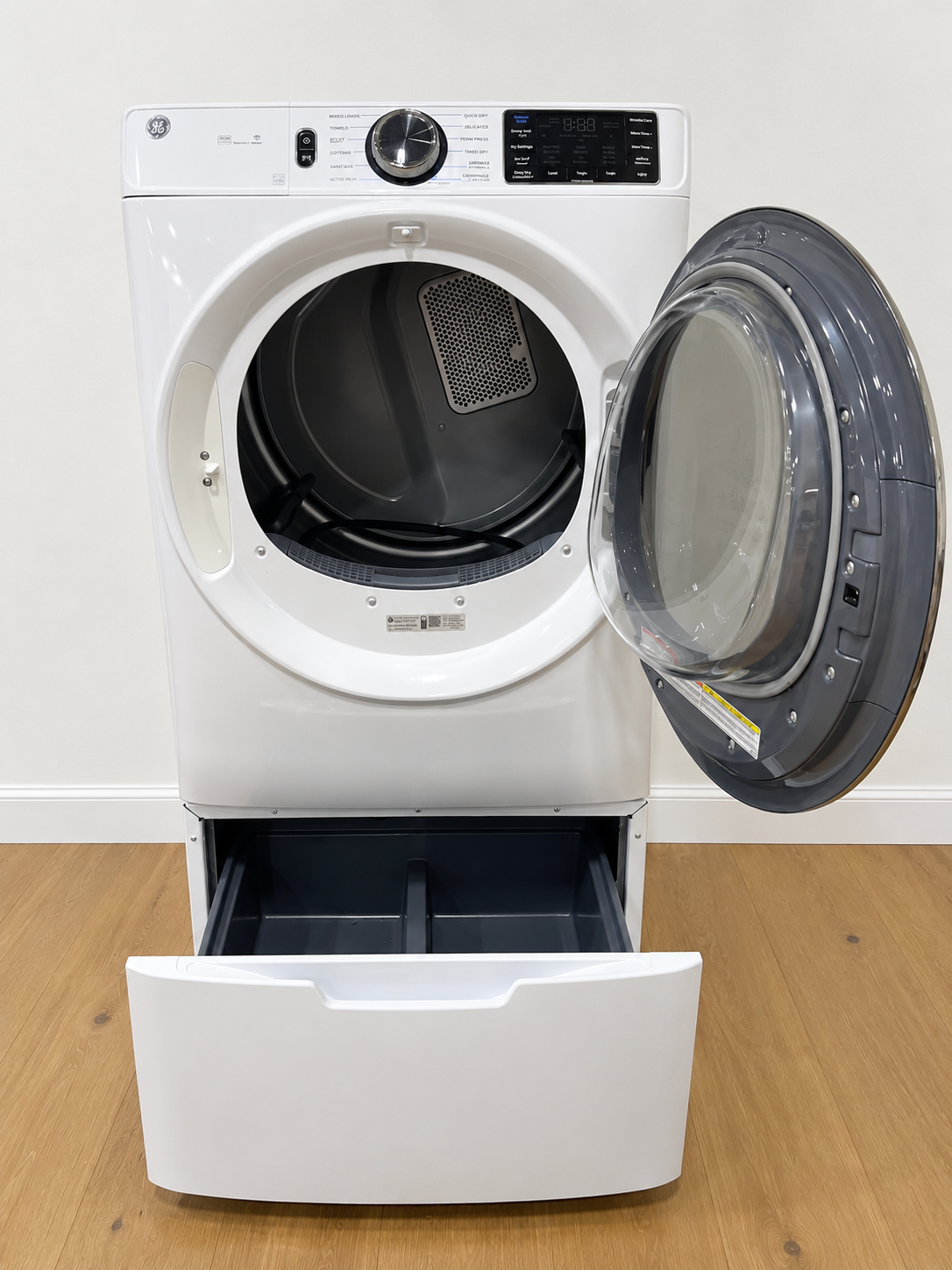 Actual unit with door open showing the empty interior and open storage pedestal drawer