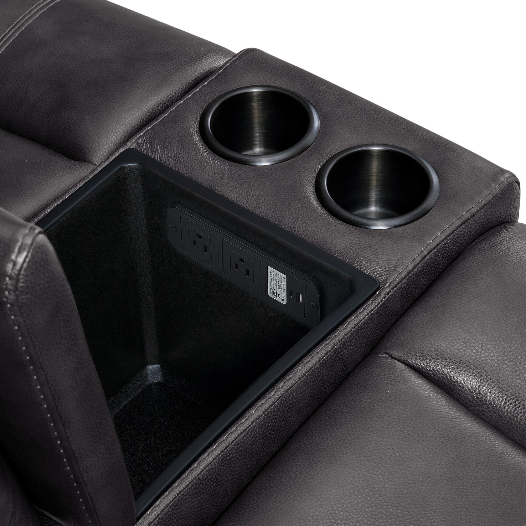 Close-up of the storage console with stainless steel cup holders, power outlets, and USB charging ports