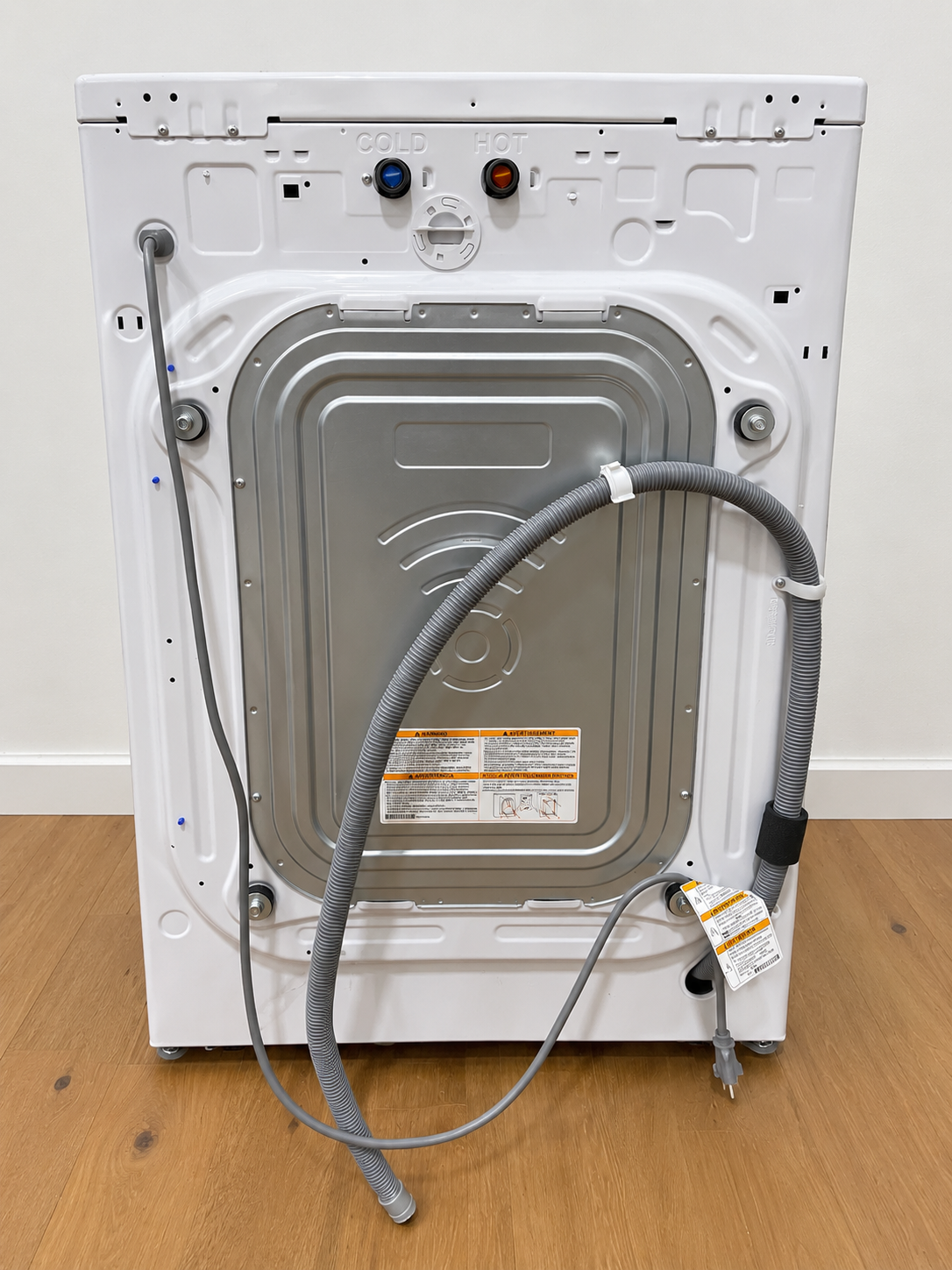 Back panel of the actual unit showing hot/cold water connections and power cord