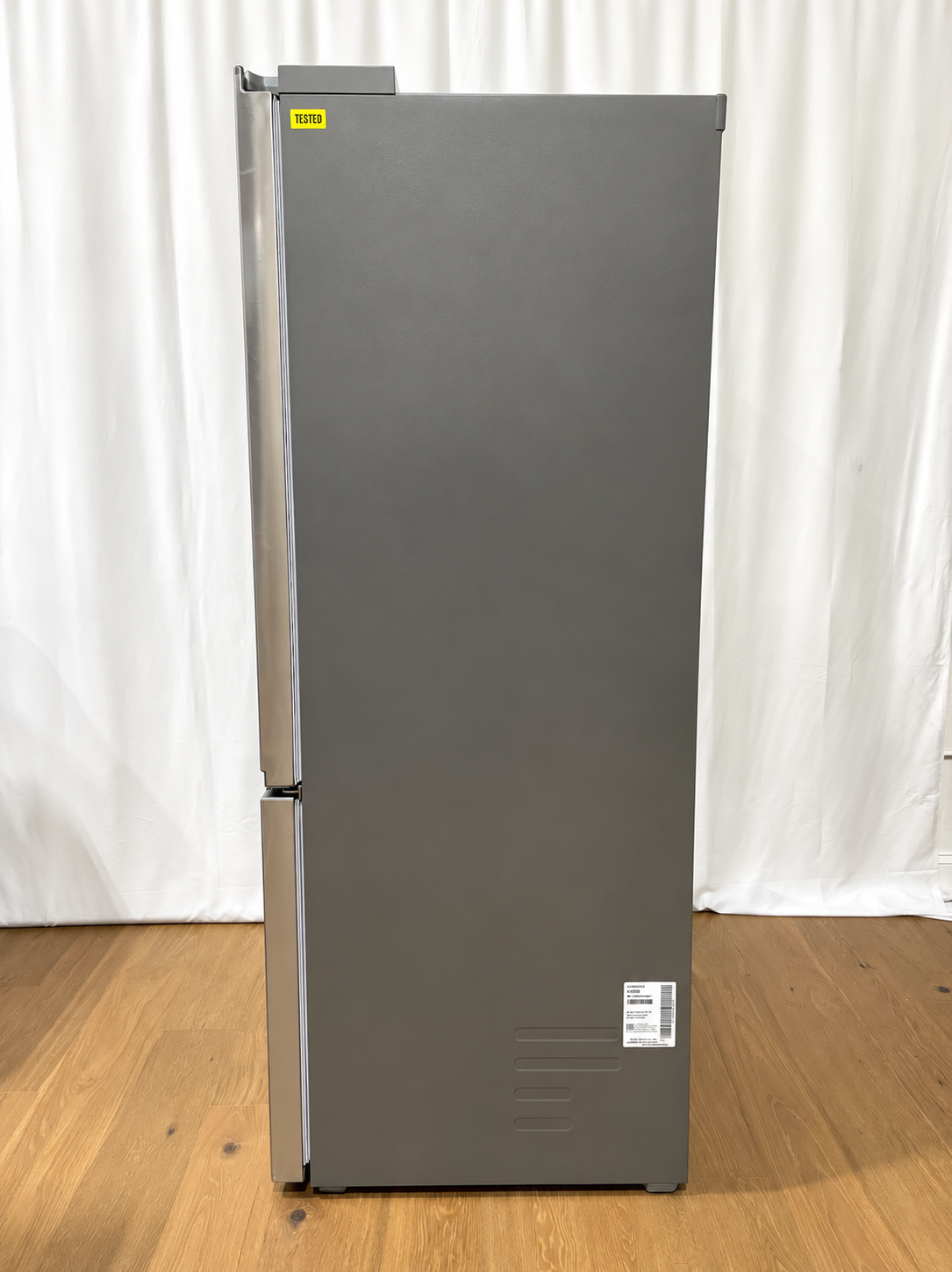 A tall, dark gray double-door refrigerator with stainless steel handles.