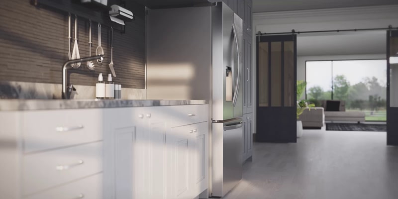 Lifestyle shot of the stainless steel refrigerator with a door slightly open in a modern loft-style kitchen with dark cabinetry and barn doors