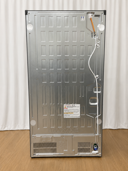 Back panel of the refrigerator showing condenser coils, wiring, and the Cyclopentane refrigerant label