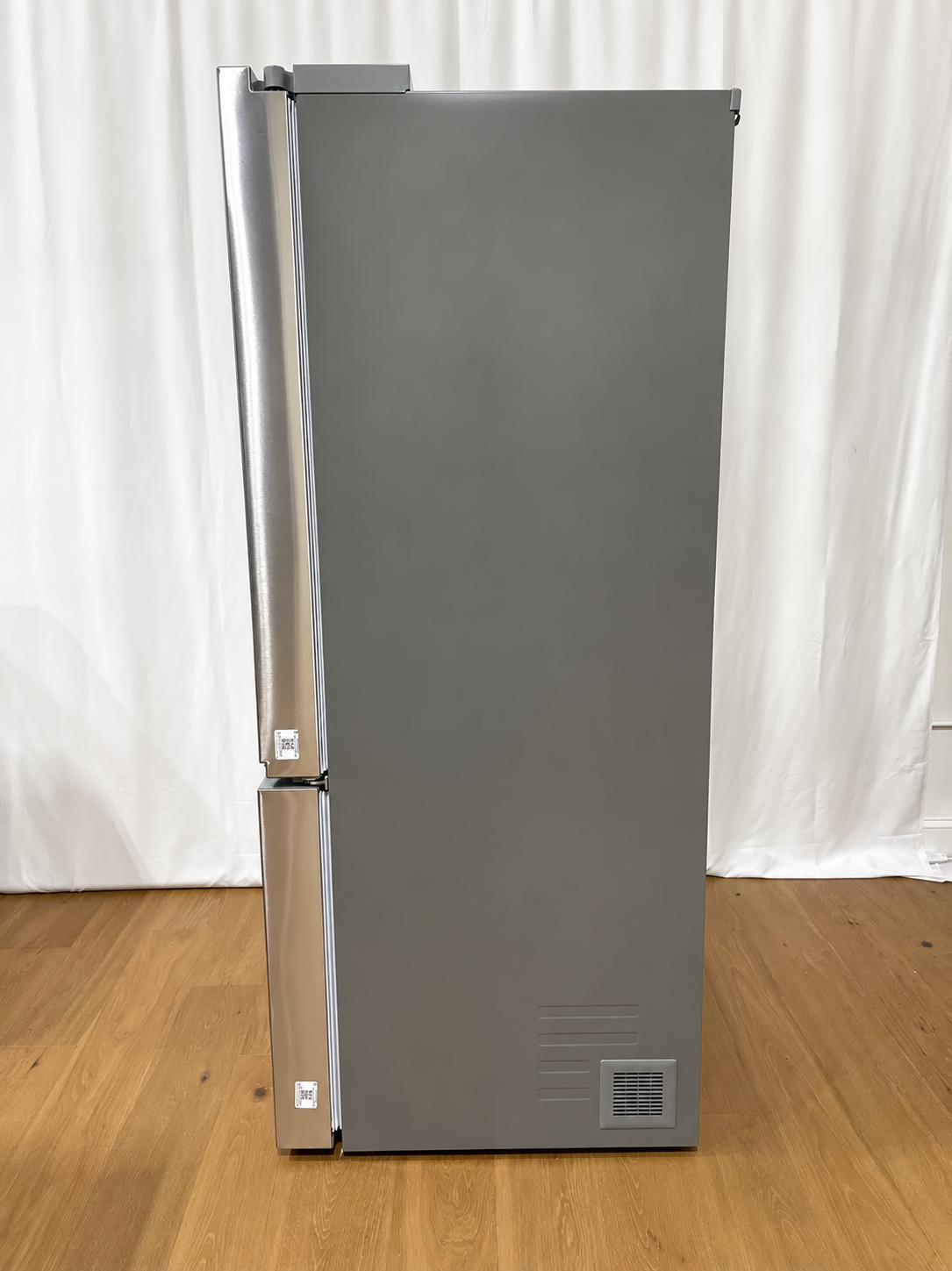 A tall, stainless steel double-door refrigerator with a brushed metal finish.
