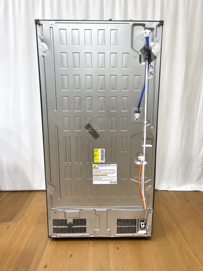 The back panel of a stainless steel appliance, likely a refrigerator or freezer, standing upright.