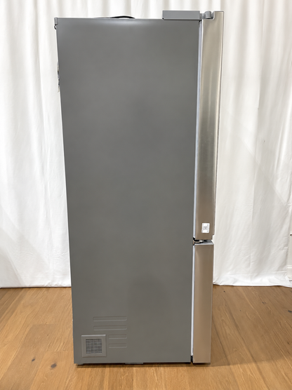 A tall, stainless steel refrigerator with a bottom freezer drawer.