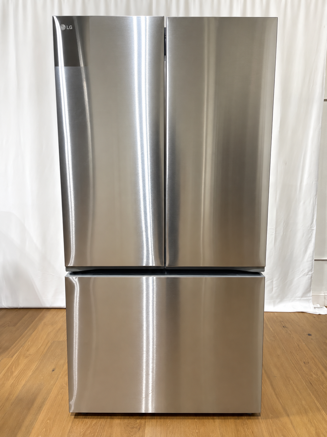 An LG stainless steel French door refrigerator with a bottom freezer drawer.