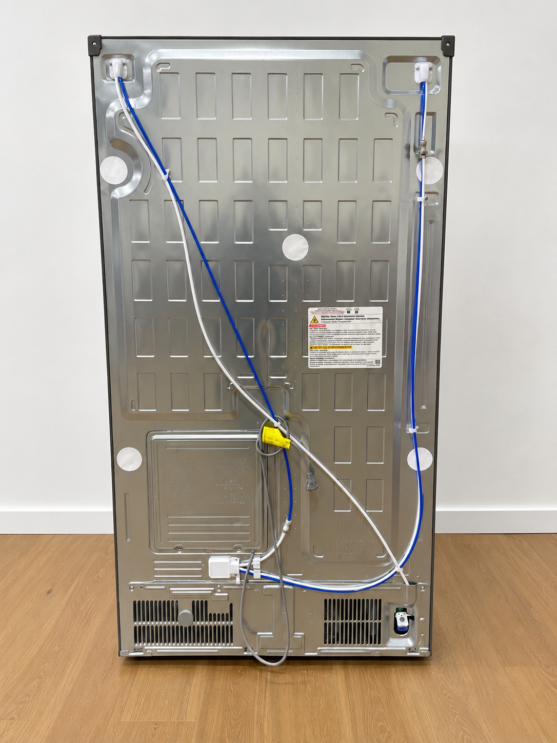 Back panel of the actual unit showing water line connections and rating label