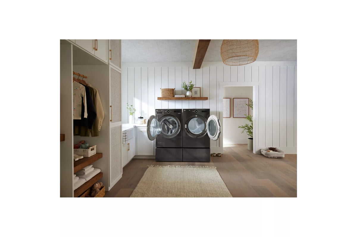 LG WM6700HBA black steel washer and dryer with doors open in a bright laundry room