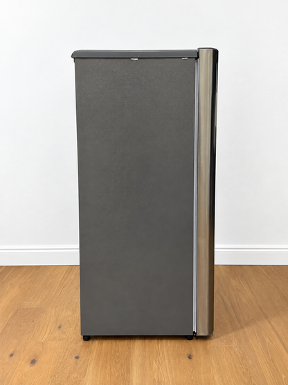 A tall, narrow refrigerator or freezer with a dark gray textured front door and a metallic silver vertical handle.