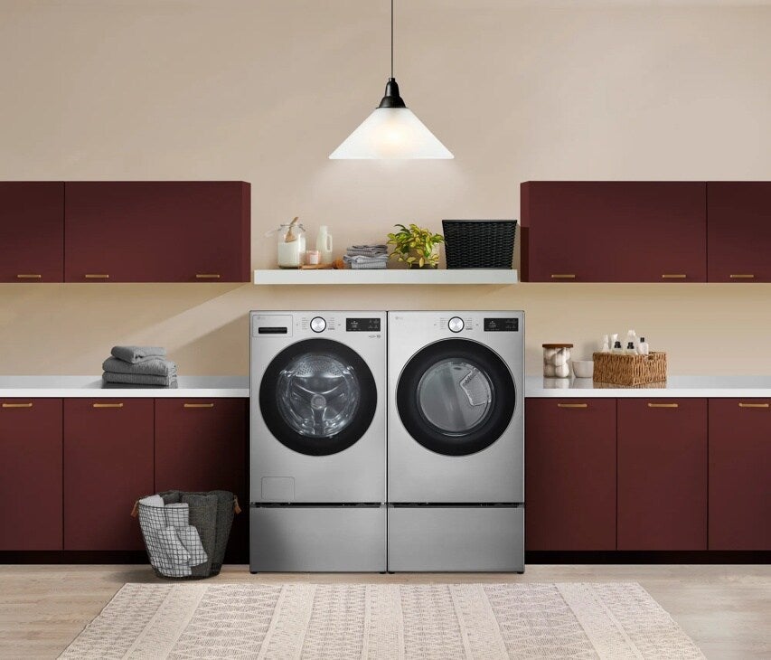 Dryer shown side-by-side with a matching LG washer in a laundry room, lifestyle shot