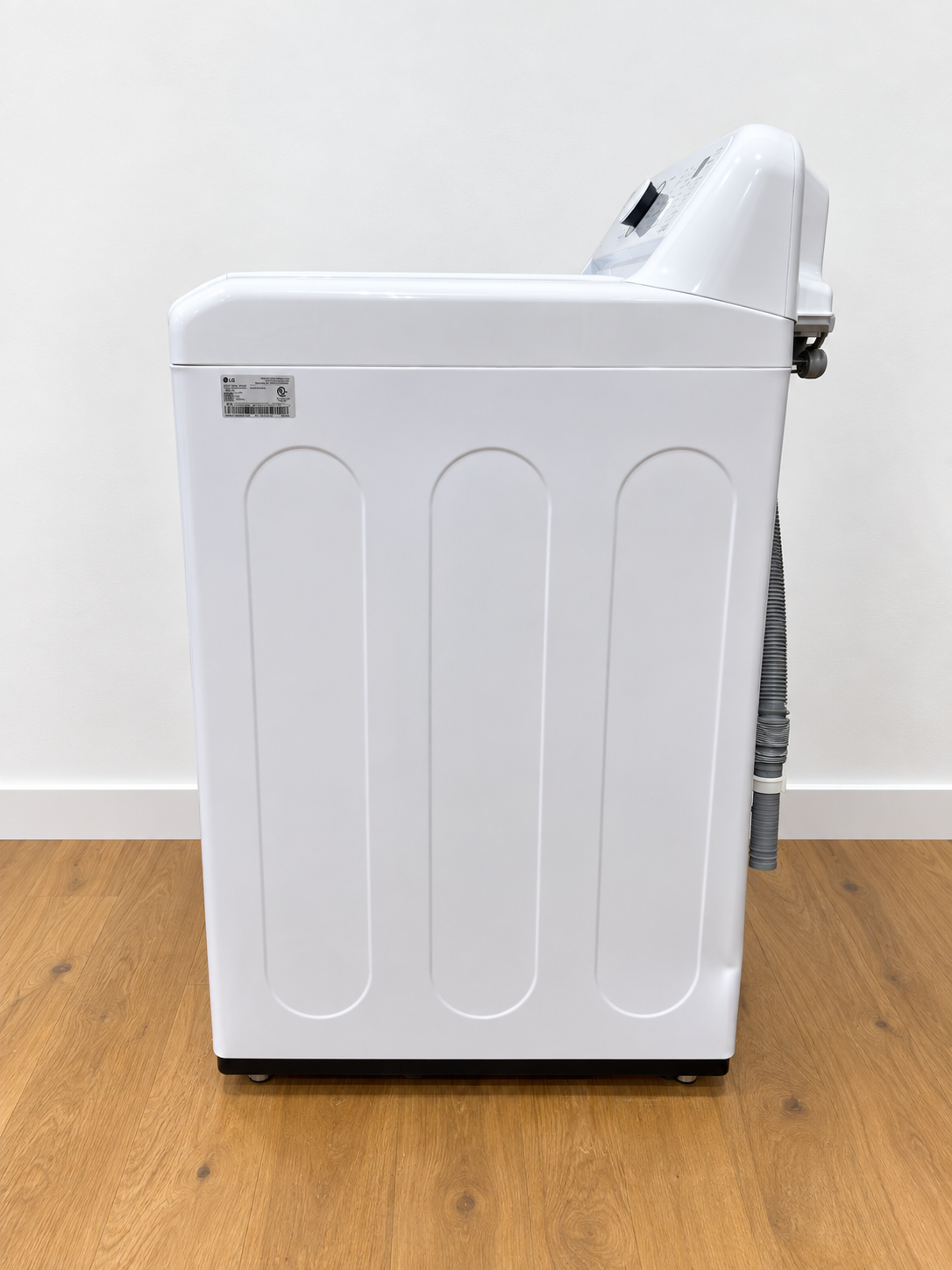 LG WT7005CW side view showing model label and water hoses