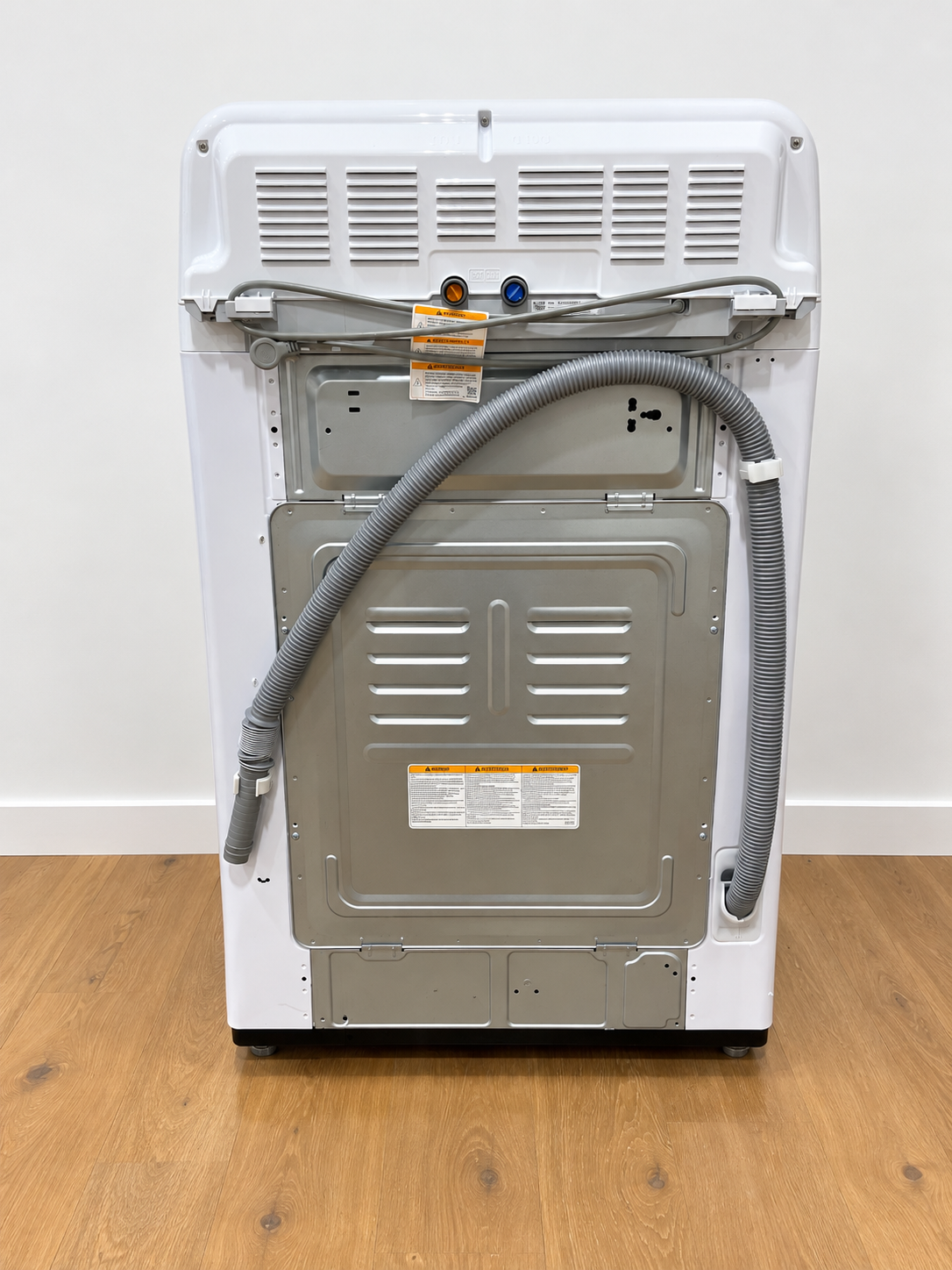 LG WT7005CW rear panel showing ventilation and water supply connections