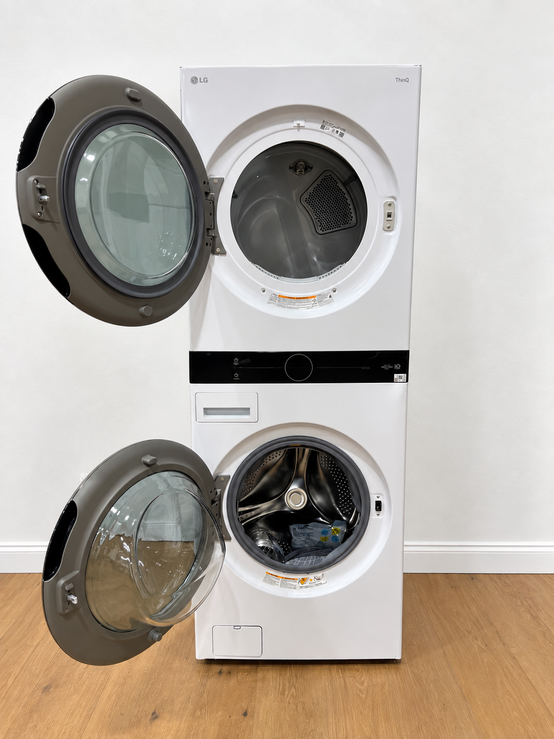 LG WKEX200HWA WashTower rear panel showing power cord, water hoses, and vent connections