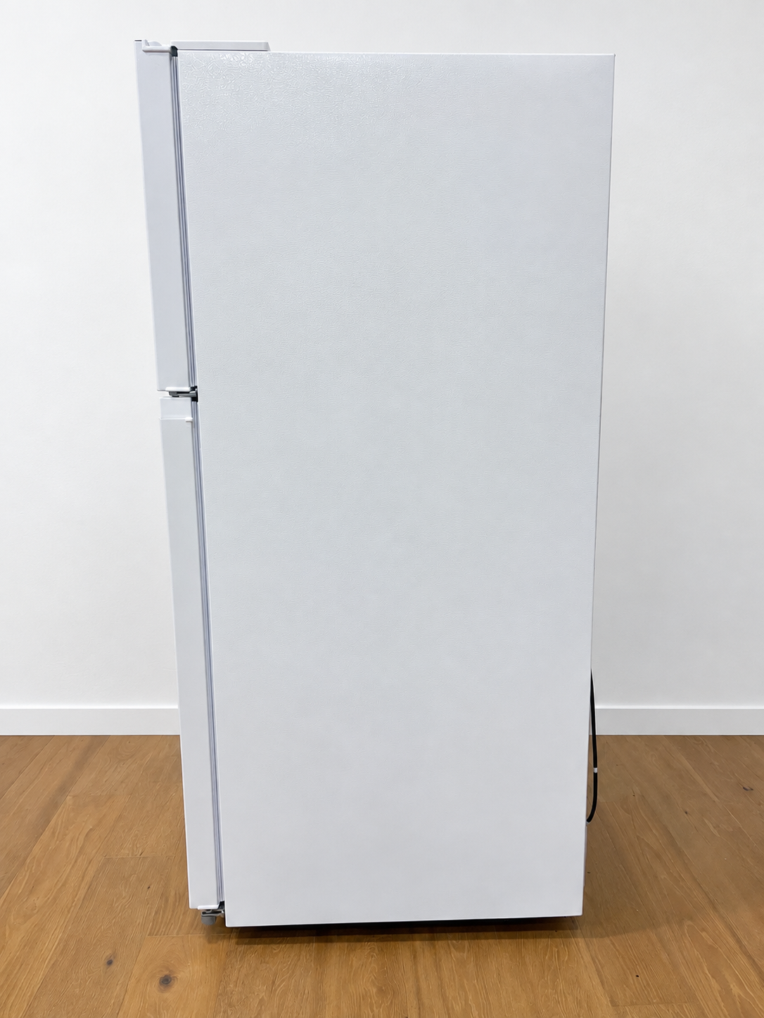 A white two-door refrigerator standing upright.