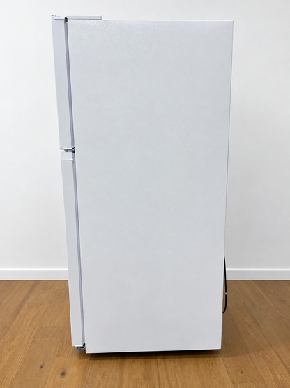 A white two-door refrigerator standing upright.