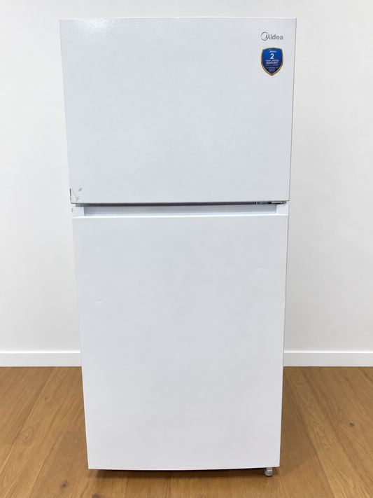 A white Midea top-freezer refrigerator standing.