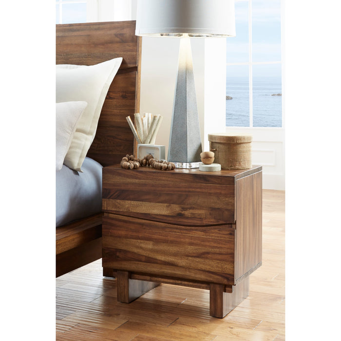 Modus Ocean 2-drawer nightstand in natural Sengon wood shown bedside with lamp and decor