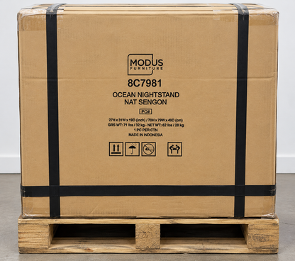 Modus Furniture shipping box labeled 8C7981 Ocean Nightstand Nat Sengon on a wooden pallet