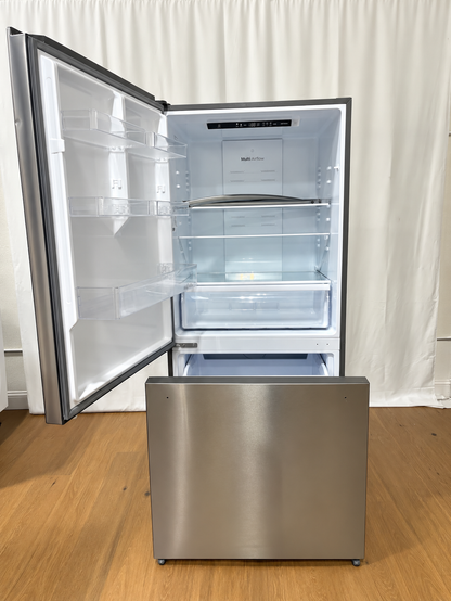 A stainless steel bottom-freezer refrigerator with its door open, showing the interior shelves and light box.