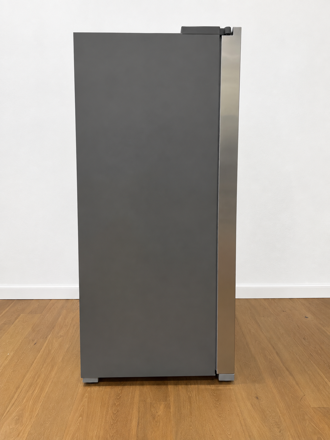 A tall, narrow refrigerator or freezer with a dark gray front door and a brushed stainless steel side panel.