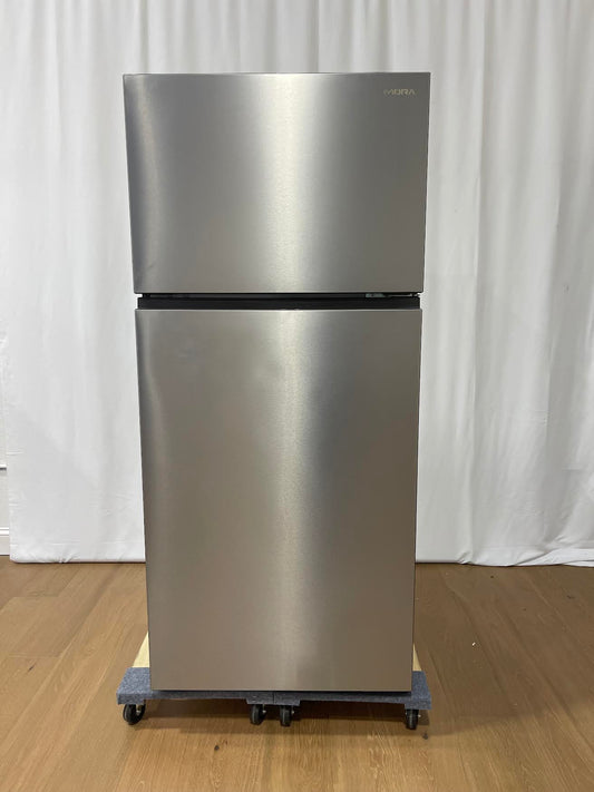A stainless steel top-freezer refrigerator on a dolly with casters, standing on a wooden floor against a white curtain backdrop.