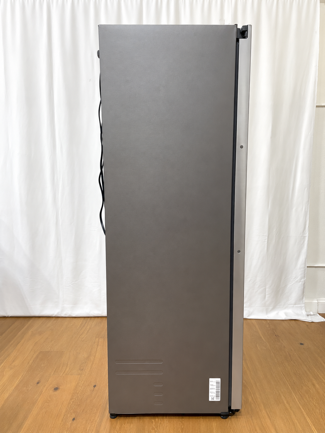 A tall, dark gray refrigerator shown from the side.