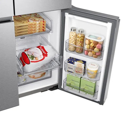Close-up of a door bin stocked with frozen turkey, snacks, and baked goods