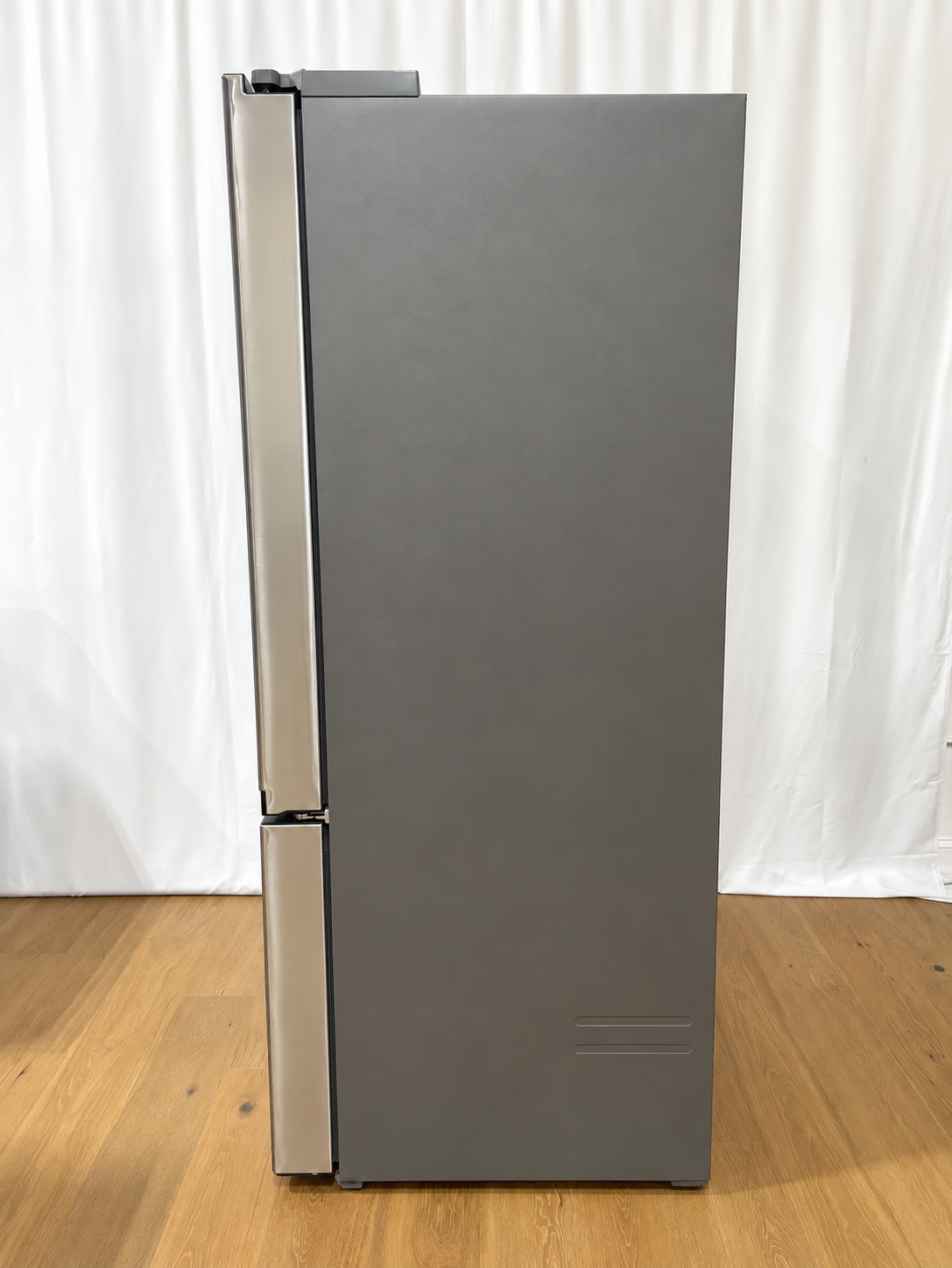A tall, dark gray refrigerator with stainless steel handles.