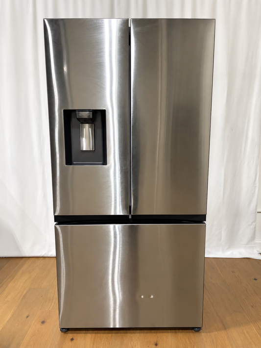 A stainless steel French door refrigerator with a bottom freezer drawer and an integrated water and ice dispenser on the left door.