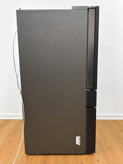Side view of the actual unit with protective plastic wrap and a yellow Tested quality-control sticker