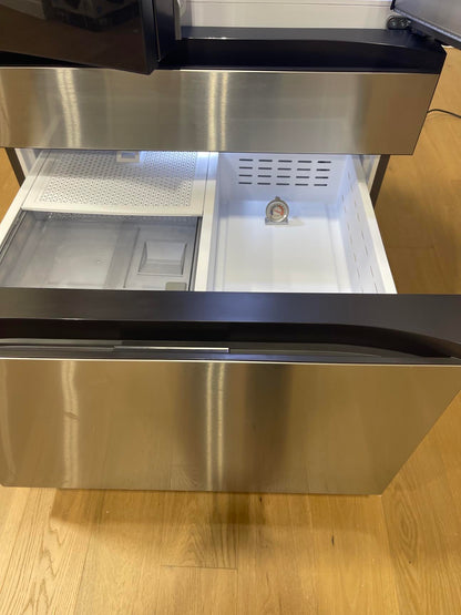 Close-up of the open freezer drawer with a thermometer placed inside to verify temperature