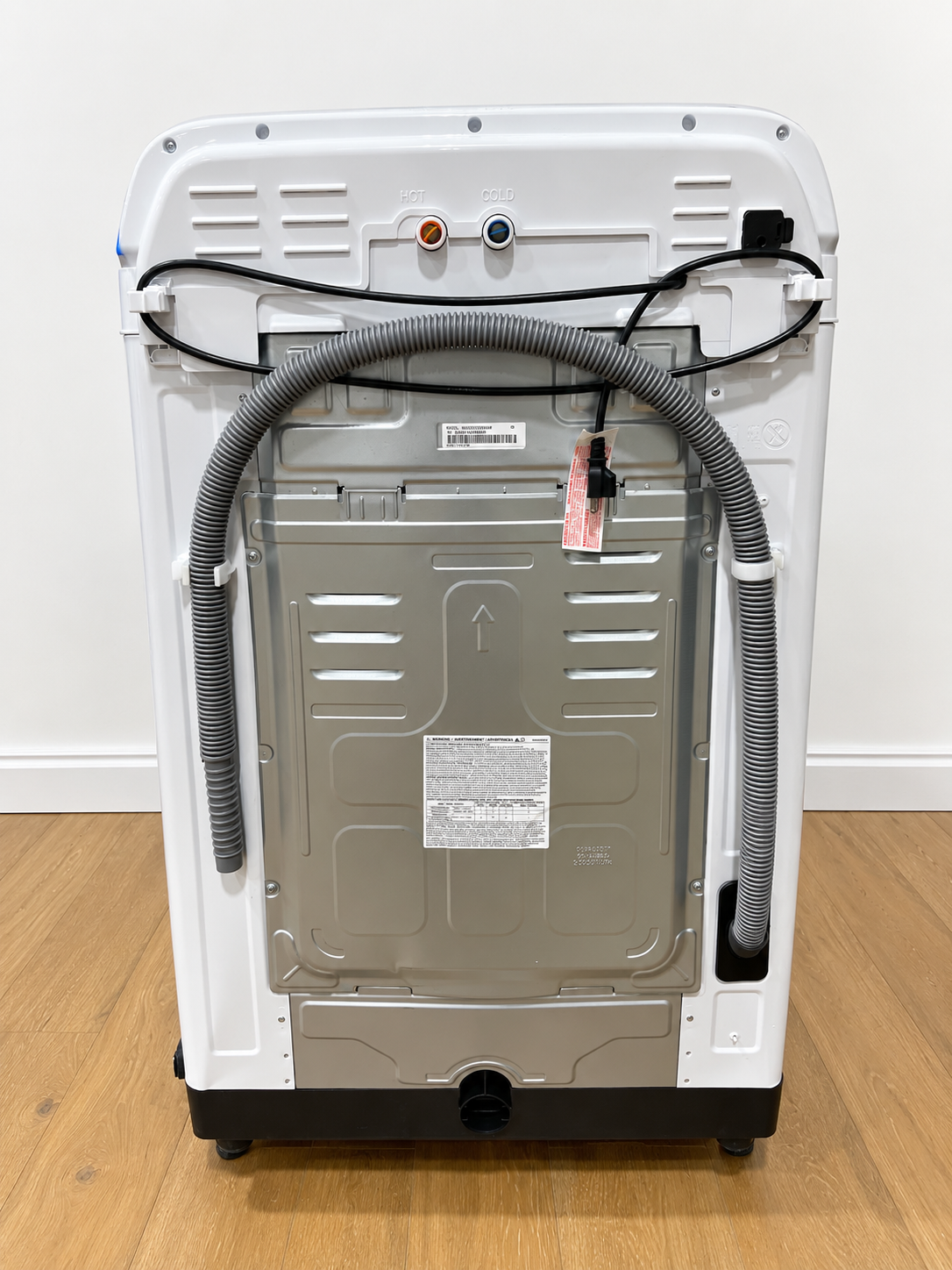 Back panel of the actual unit showing hot/cold water connections and hoses