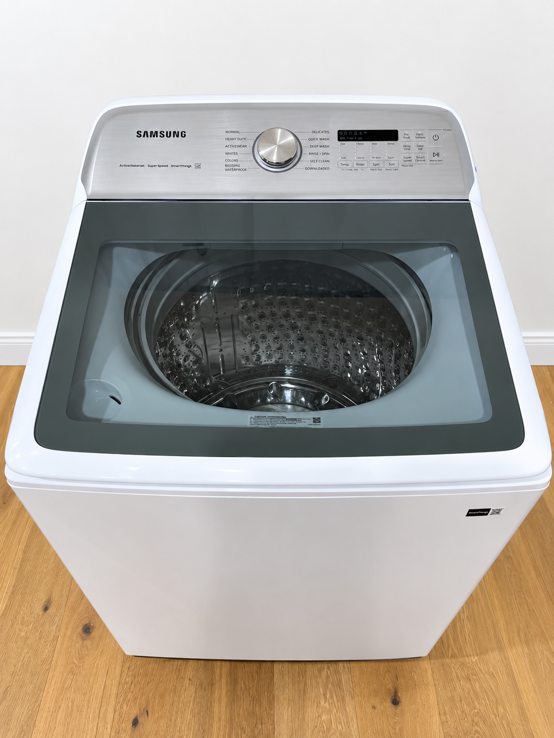 Actual unit with lid open showing the empty tub and control panel