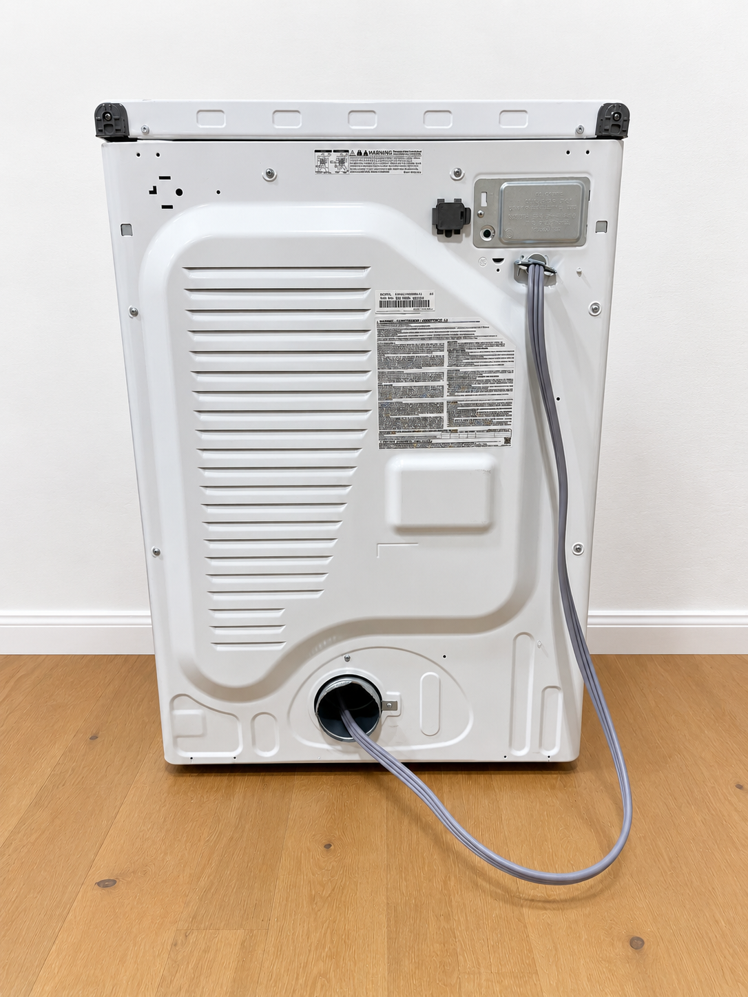 Samsung DVE45T6000W dryer back panel showing power cord, exhaust vent, and rating label
