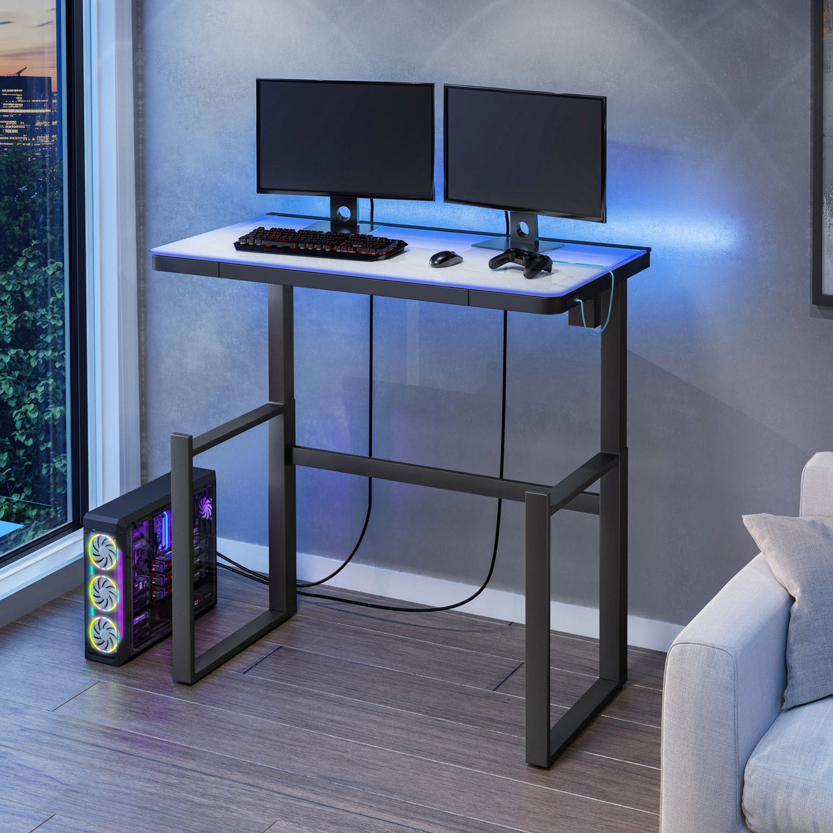 Tresanti Aurora desk raised to standing height with dual monitors and blue LED lighting