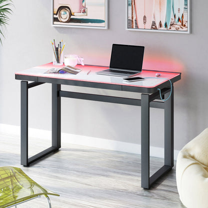 Tresanti Aurora 47 inch adjustable height desk with pink LED glow, white glass top and charcoal frame in a home office