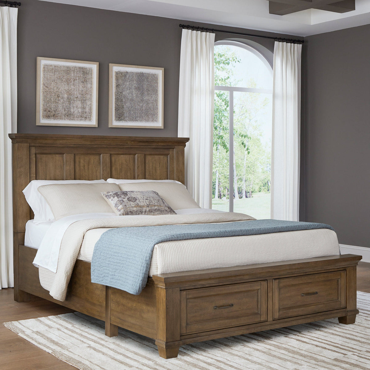 Universal Broadmoore Pierson queen storage bed in dark caramel finish with panel headboard and two footboard drawers in a bedroom